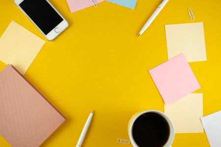 Minimalistic workplace concept, with a smartphone, pen and business work records on a dark background. Image digital, marketing, design agency. Top view. Flat lay styleの写真素材