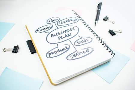 Minimalistic workplace concept, with a stationery, pen and business work records on a white...