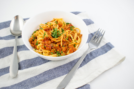 Spaghetti bolognese on a white plate. Italian cuisine concept, food ingredients. Close up view.の写真素材
