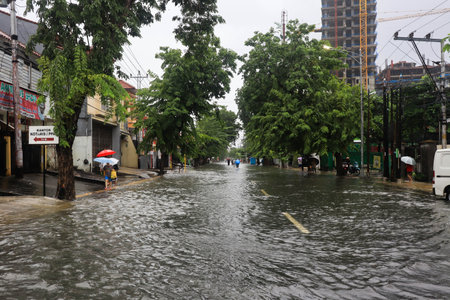 Semarang, December 2022. Some people are walking through the flood that hit the Poncol train station area and some residents are preparing to evacuate. conditions during the floodのeditorial素材