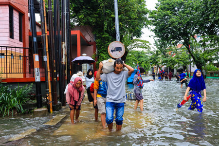 Semarang, December 2022. Some people are walking through the flood that hit the Poncol train station...