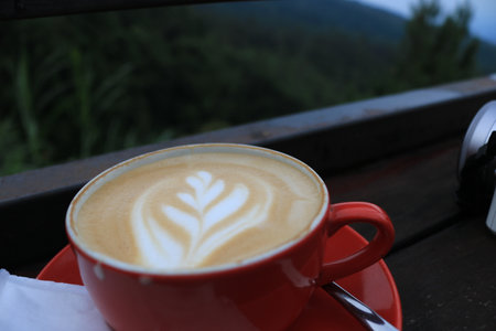 cup of cappuccino with latte art on wooden background.の写真素材
