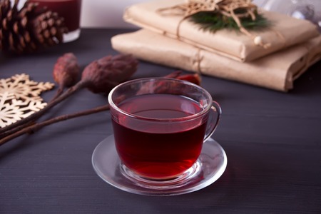 Cup of tea on the wooden table and other decorative Christmas objectsの写真素材