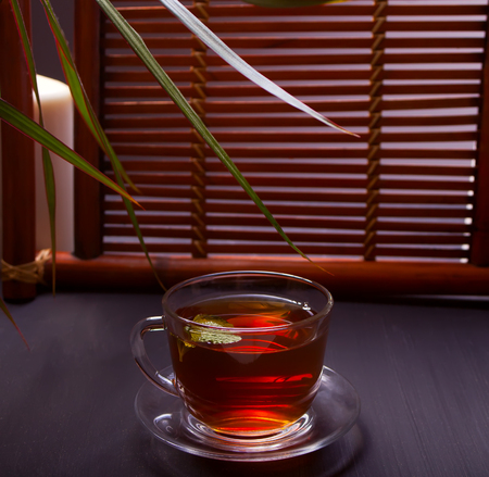 Cup of mint tea on a wooden background.の写真素材