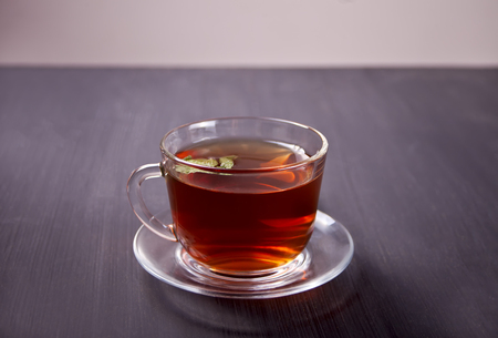 Cup of mint tea on a wooden background.の写真素材