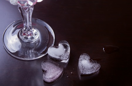 Drink with ice in a heart shape on the black backgroundの写真素材