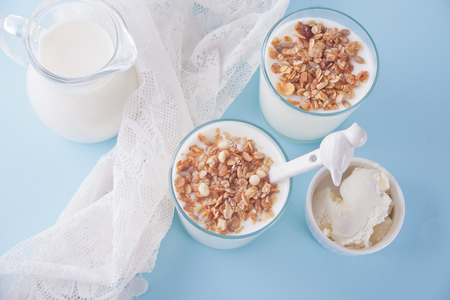 Yogurt in glass, milk and cream cheese on a table with white napkin. Top view.の写真素材