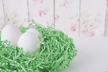 Easter eggs in a nest on the tableの写真素材