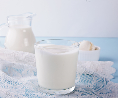 Yogurt in glass, milk and cream cheese for a breakfast on a white napkinの写真素材