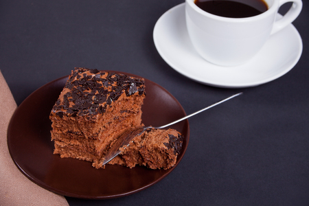 Delicious chocolate cake on the plate on the black tableの写真素材