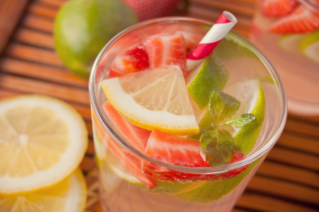 Strawberry Lemonade or mojito cocktail with lemon and mint, cold refreshing drink or beverage with ice.の写真素材