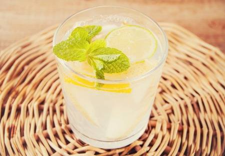 Lemonade or mojito cocktail with lemon and mint, cold refreshing drink or beverage with ice.の写真素材