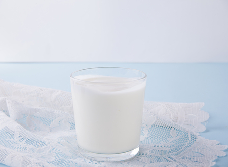 Yogurt in glass and spoon on a napkinの写真素材