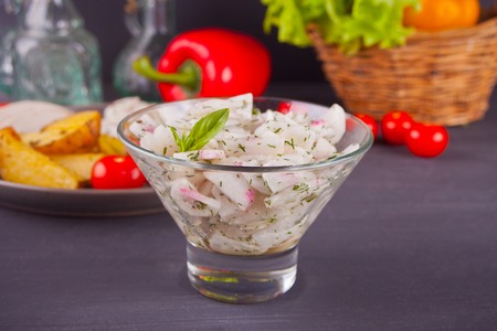 Spring salad with radishes with vegetables on the backgroundの写真素材