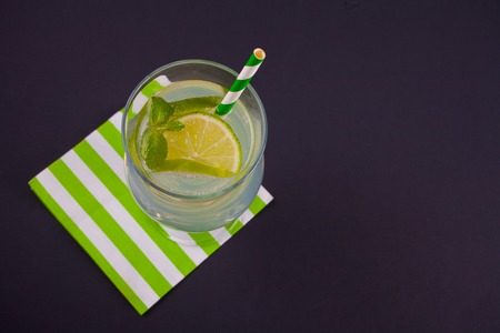 Lemonade or mojito cocktail with lemon and mint, cold refreshing drink or beverage with ice. Top view.の写真素材