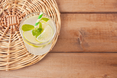 Lemonade or mojito cocktail with lemon and mint, cold refreshing drink or beverage with ice. Top view.の写真素材