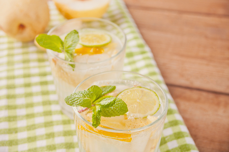 Lemonade or mojito cocktail with lemon and mint, cold refreshing drink or beverage with ice.の写真素材