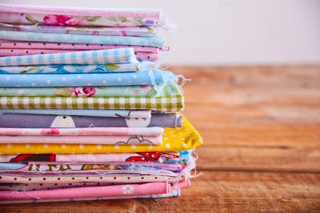 stack of of new fabrics in different colors cloth with copy space.