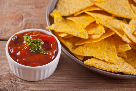 Nachos with salsa dip on the wooden tableの写真素材
