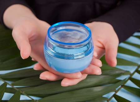Beautiful hands of young woman with the jar of cream.の写真素材