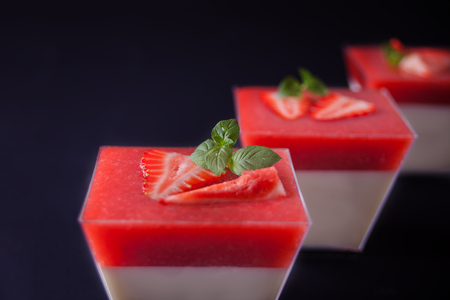 Dessert panna cotta with fresh berries on the black background, selective focus.の写真素材