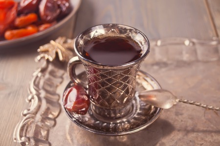 Turkish tea in cup and sweets on the metal tray. Oriental.の写真素材