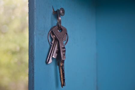Hanging keys on the wall, Various keys hanging on blue wall