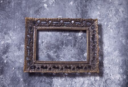 antique metal bronze frame on the gray backgroundの写真素材