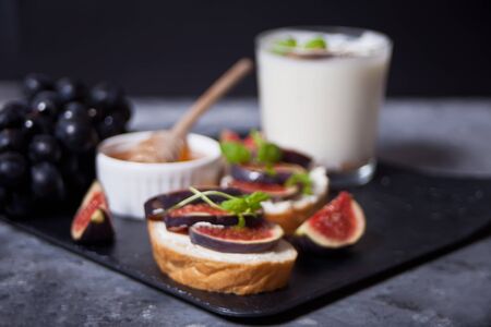 Sandwich with cream cheese, figs and honey. Healthy food concept.の写真素材