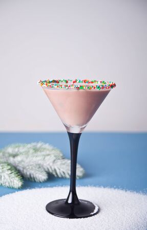 Glass of winter season chocolate cocktail, christmas tree branch on the blue background.の写真素材