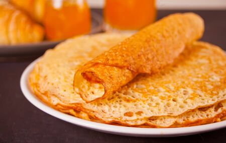 homemade russian thin tasty pancakes on the plateの写真素材