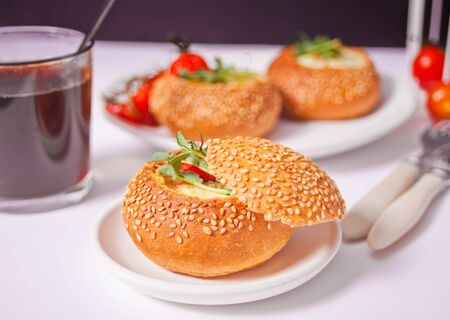 Egg served in bread bowl. Breakfast baked eggs in bread bowls with the fresh herbs