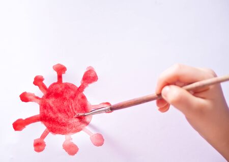 Child drawing watercolor paints and brush a corona virus covid-19の写真素材