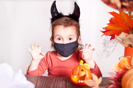 funny child girl in evil costume for Halloweenの写真素材