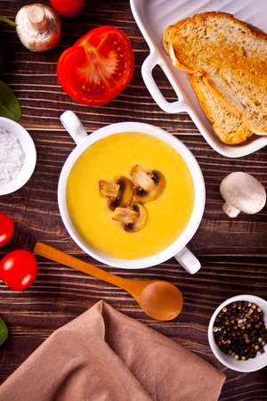 Cheese or onion cream soup with toasts bread in a white bowlの写真素材