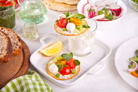 Round crispbread toast with greens and vegetables. Healthy food concept.の写真素材