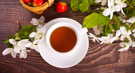 Cup of tea with white apple blossoms. Spring concept.の写真素材