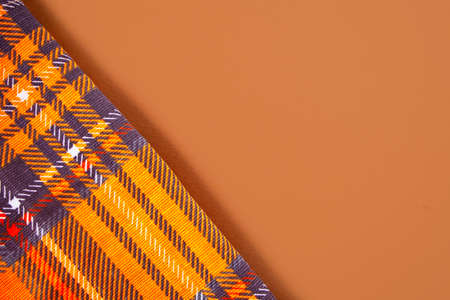 autumn colored napkin on orange background. Top view. Copy space.の写真素材
