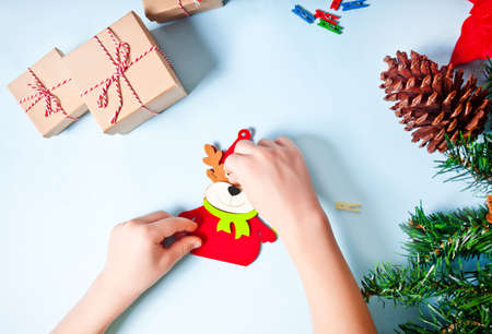 Kids making Deer decor for Christmas tree or gifts. Christmas handmade diy project.の写真素材