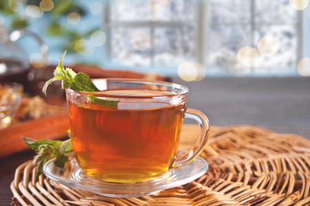 Cup of herbal mint tea with dry herbs on the tray.の写真素材