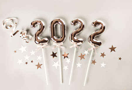 Christmas decoration with silver toys, stars, balls and 2022 numbers. Top view.