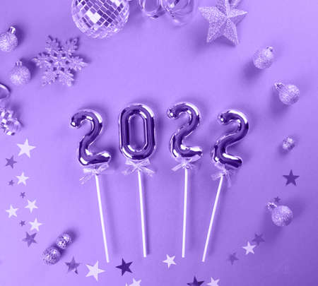Christmas decoration with toys, stars, balls and 2022 numbers in new pontone color very peri. Top...