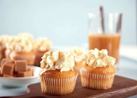 Homemade cupcakes with caramel syrup and whipped cream cheeseの写真素材