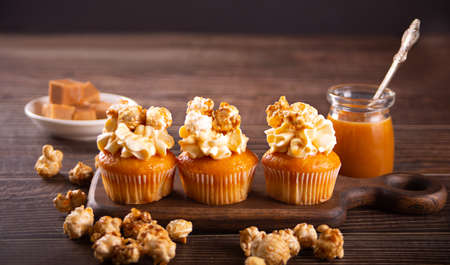 Homemade cupcakes with caramel popcorn and whipped cream cheeseの写真素材