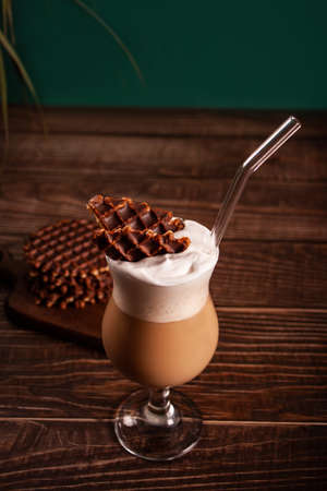 Chocolate cocktail with waffles on wooden table