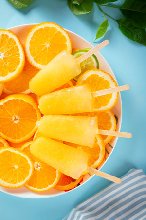 Fruit orange citrus ice pops and slices of orangeの写真素材