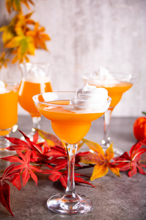 Pumpkin fall seasonal drink cocktail latte with spices and whipped cream for Thanksgiving or Halloween party festive celebrate. autumn decoration.の写真素材