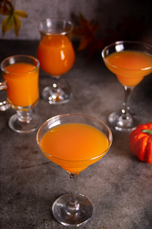 Pumpkin fall seasonal drink cocktail latte with spices and whipped cream for Thanksgiving or Halloween party festive celebrate.の写真素材