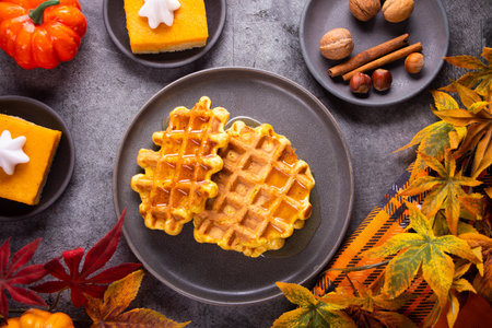 Autumn homemade pumpkin spice waffles with honey topping. top view.の写真素材