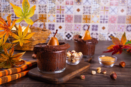 Sweet homemade autumn spicy biscuit mini pie in cup with whole pear and nutsの写真素材